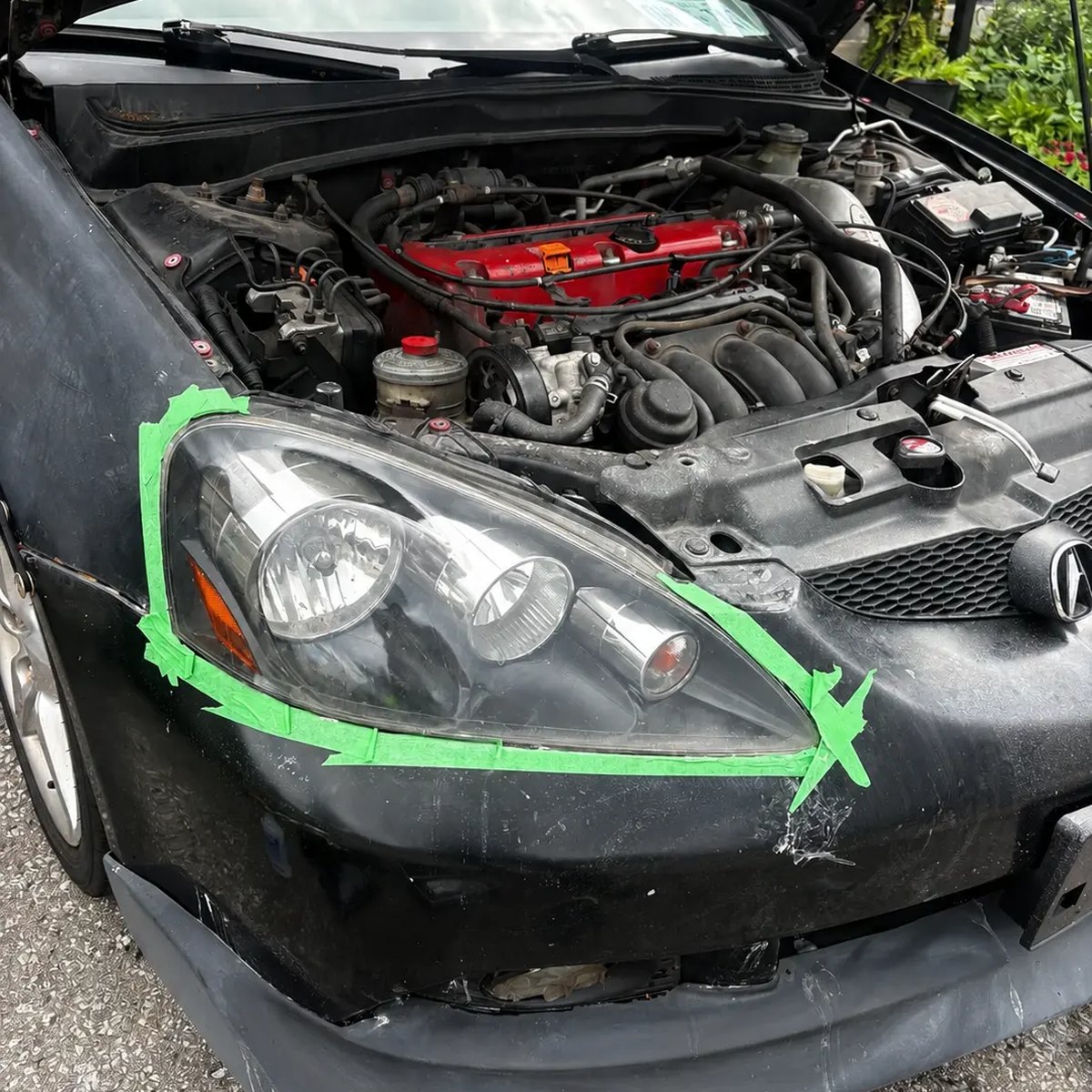 Technician machine-polishing a car headlight during a mobile restoration
